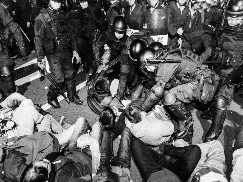 Anti-riot police aiming for students' heads and violently dragging them off the streets during a protest in Taiwan in 2014.