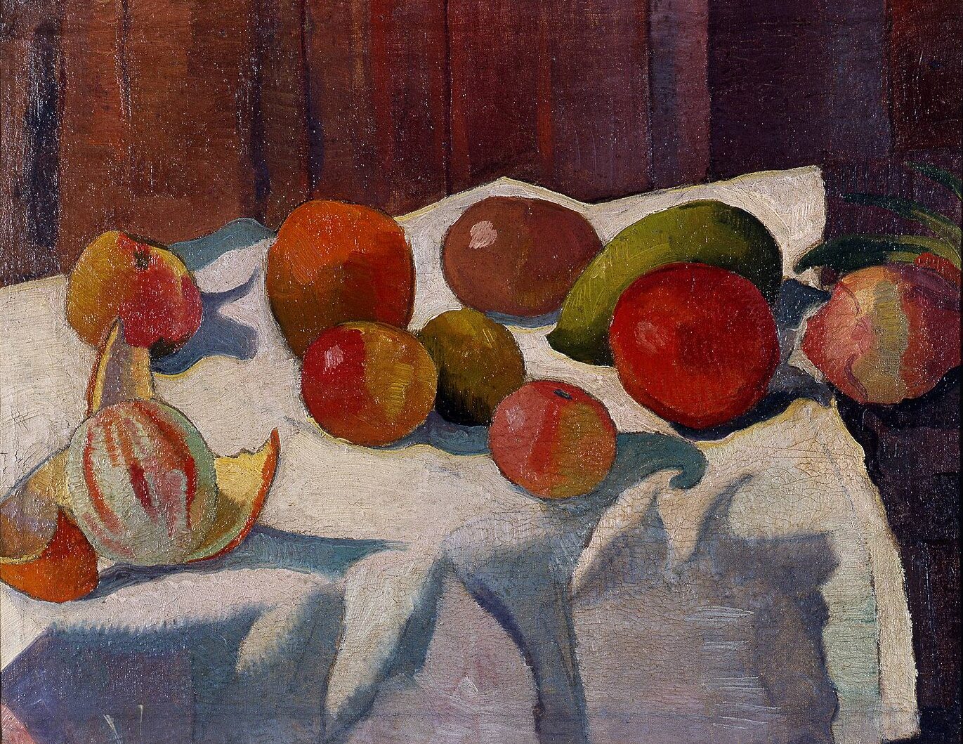 Still life of various kinds fruits laying on a tablecloth.